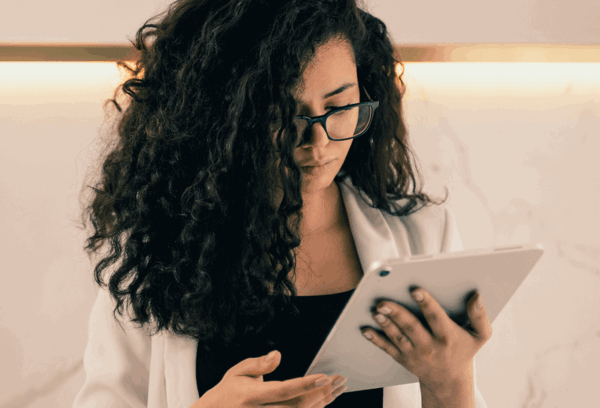 woman looking at Dynamics 365 Customer Voice on ipad