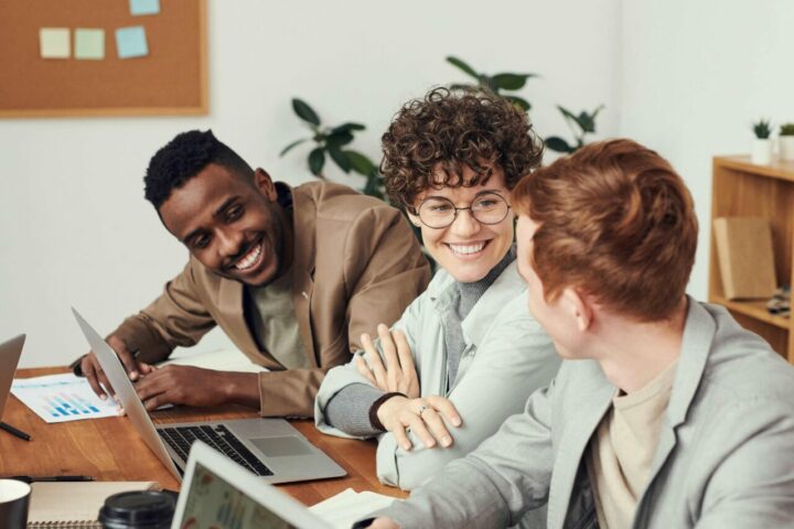 People sitting around desk discussing custom business solutions